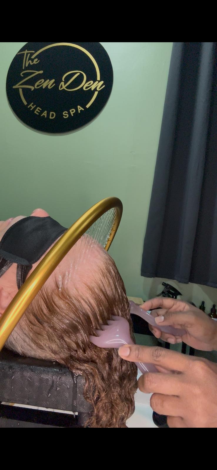 Hands working through the hair during a detailed scalp treatment and relaxation ritual.